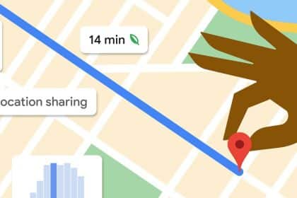 Google Maps with a hand holding a red pin pointing to a location