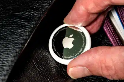 Close-up of an Apple AirTag being held.