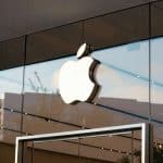 Apple logo on the glass front of an Apple Store.