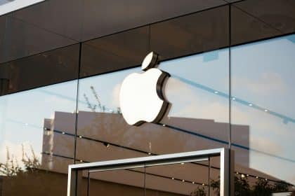 Apple logo on the glass front of an Apple Store.