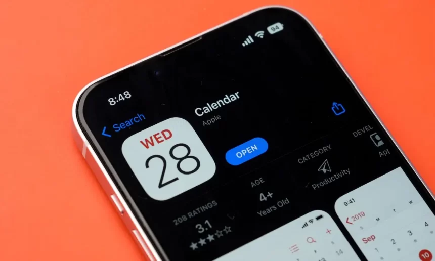 Calendar App on iPhone with orange background.