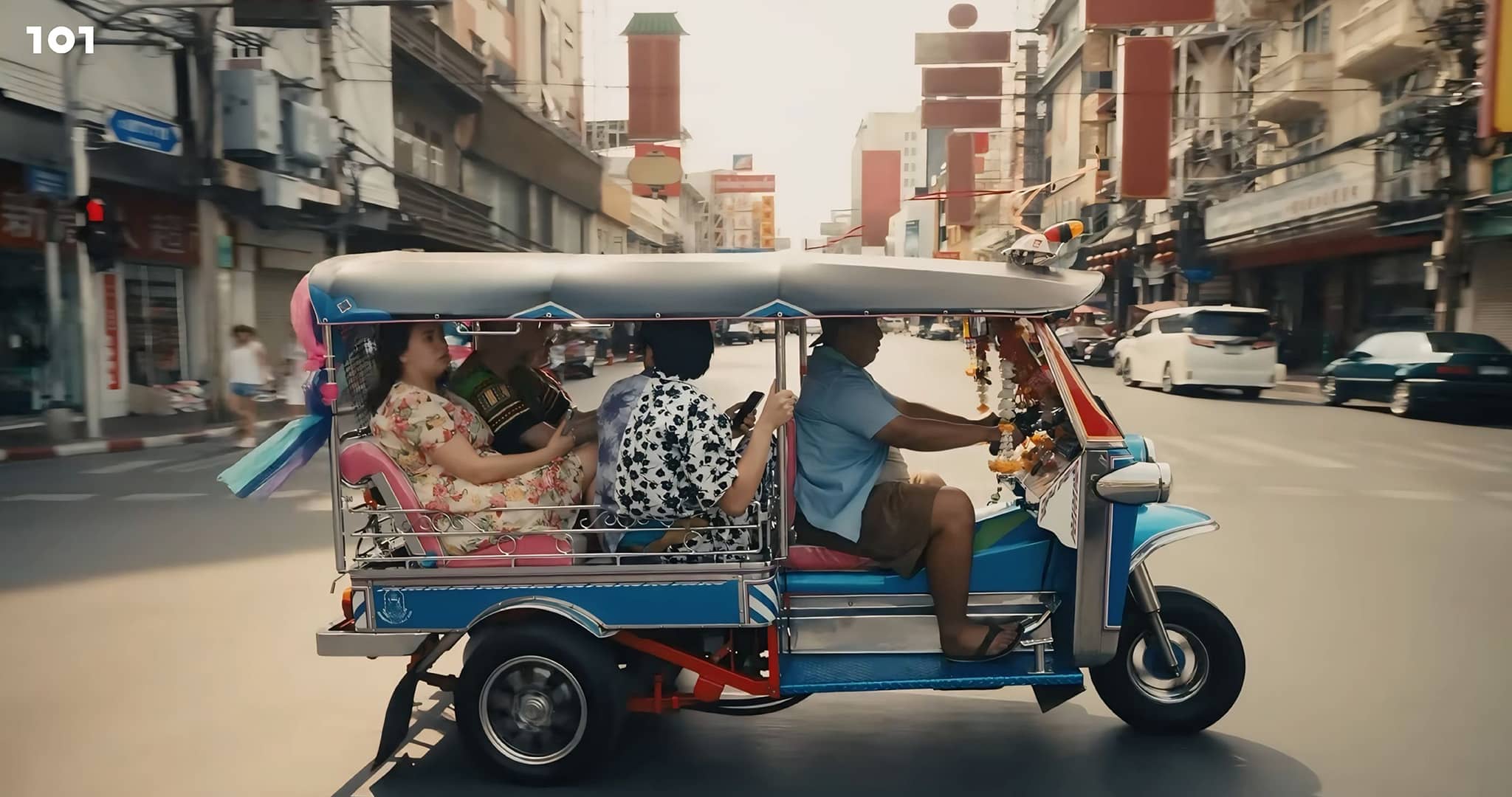 A tuk-tuk driving through a busy Thai street, showcasing vibrant local culture.