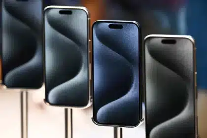 Four iPhones displayed on stands in a row.