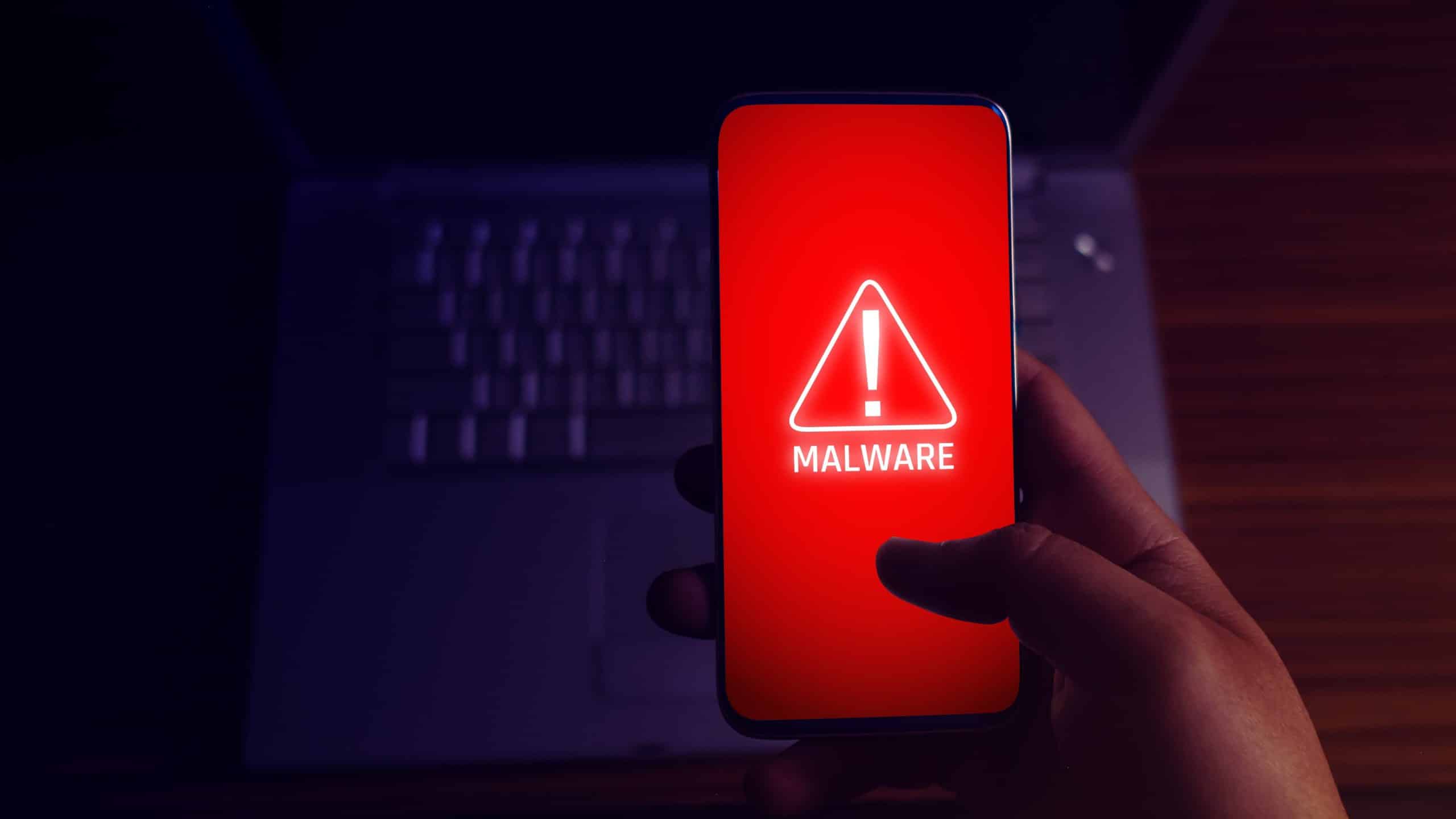 Smartphone showing a red 'Malware' alert on screen.