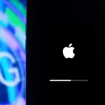 iPhone screen showing Apple logo next to a 5G graphic in the background.