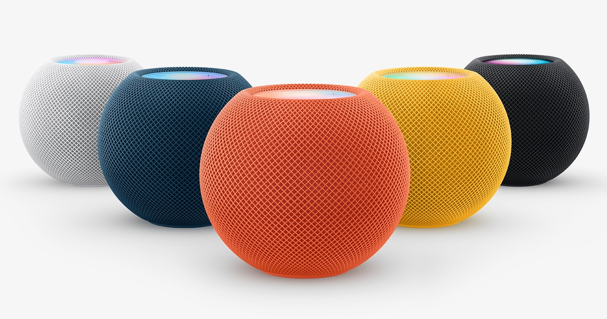 A lineup of colourful Apple HomePod mini speakers in different colours.