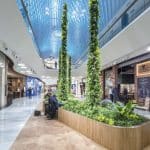 A modern shopping area with greenery at the Mall of Scandinavia.