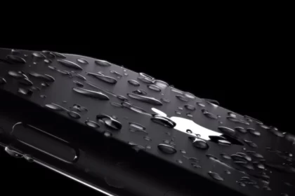 A close-up of a water-resistant iPhone with water droplets.