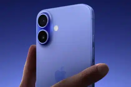 Close-up of a person holding an iPhone 16 in blue.