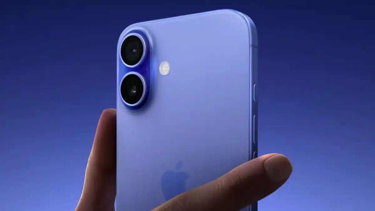 Close-up of a person holding an iPhone 16 in blue.