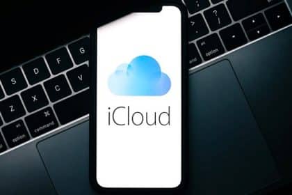 iPhone showing iCloud logo placed on a MacBook keyboard.