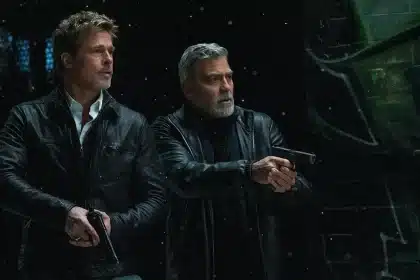 Brad Pitt and George Clooney holding guns from 'Wolfs'.