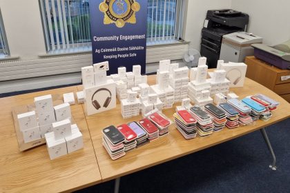 Seized counterfeit Apple products displayed on a table.