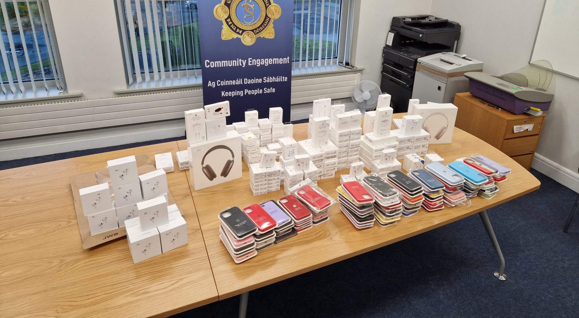 Seized counterfeit Apple products displayed on a table.