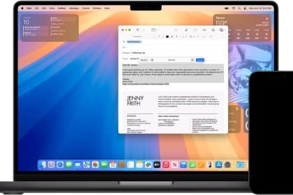 A MacBook displaying an email draft on the screen, with an iPhone beside it.