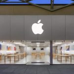 Front view of an Apple Store with a large Apple logo.