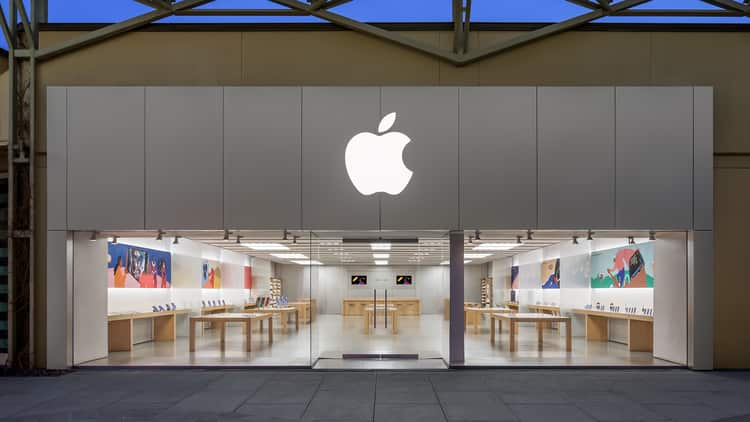 Front view of an Apple Store with a large Apple logo.