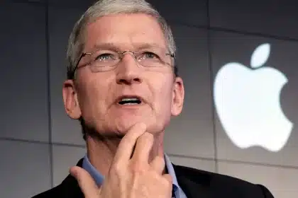 Tim Cook speaking in front of the Apple logo.