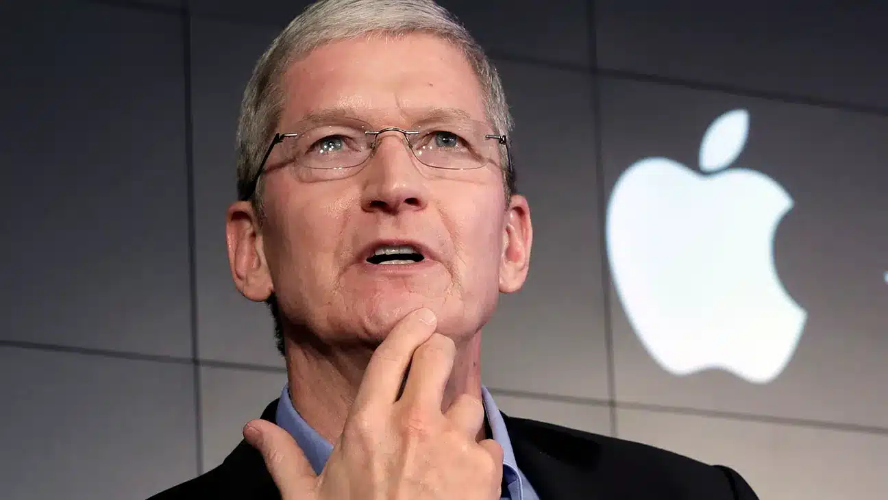 Tim Cook speaking in front of the Apple logo.