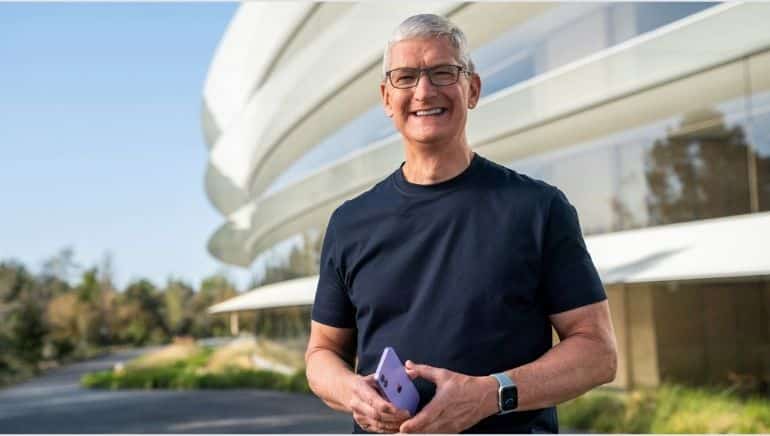 Tim Cook holding an iPhone.