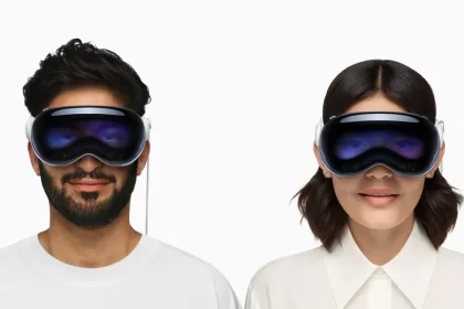 Two people wearing Apple Vision Pro headsets.