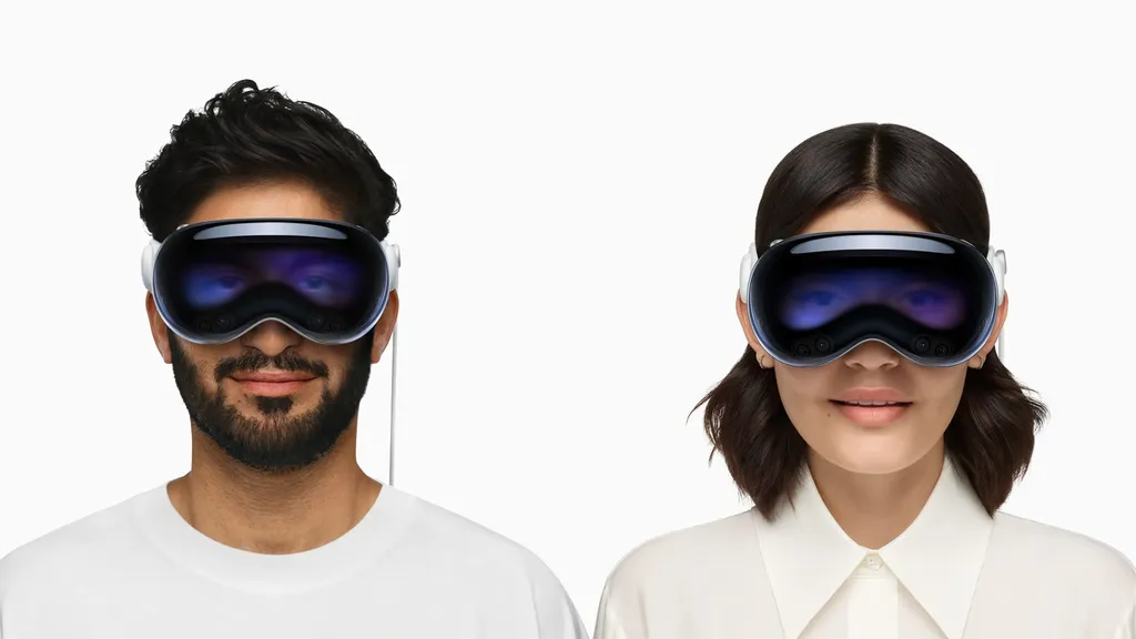 Two people wearing Apple Vision Pro headsets.