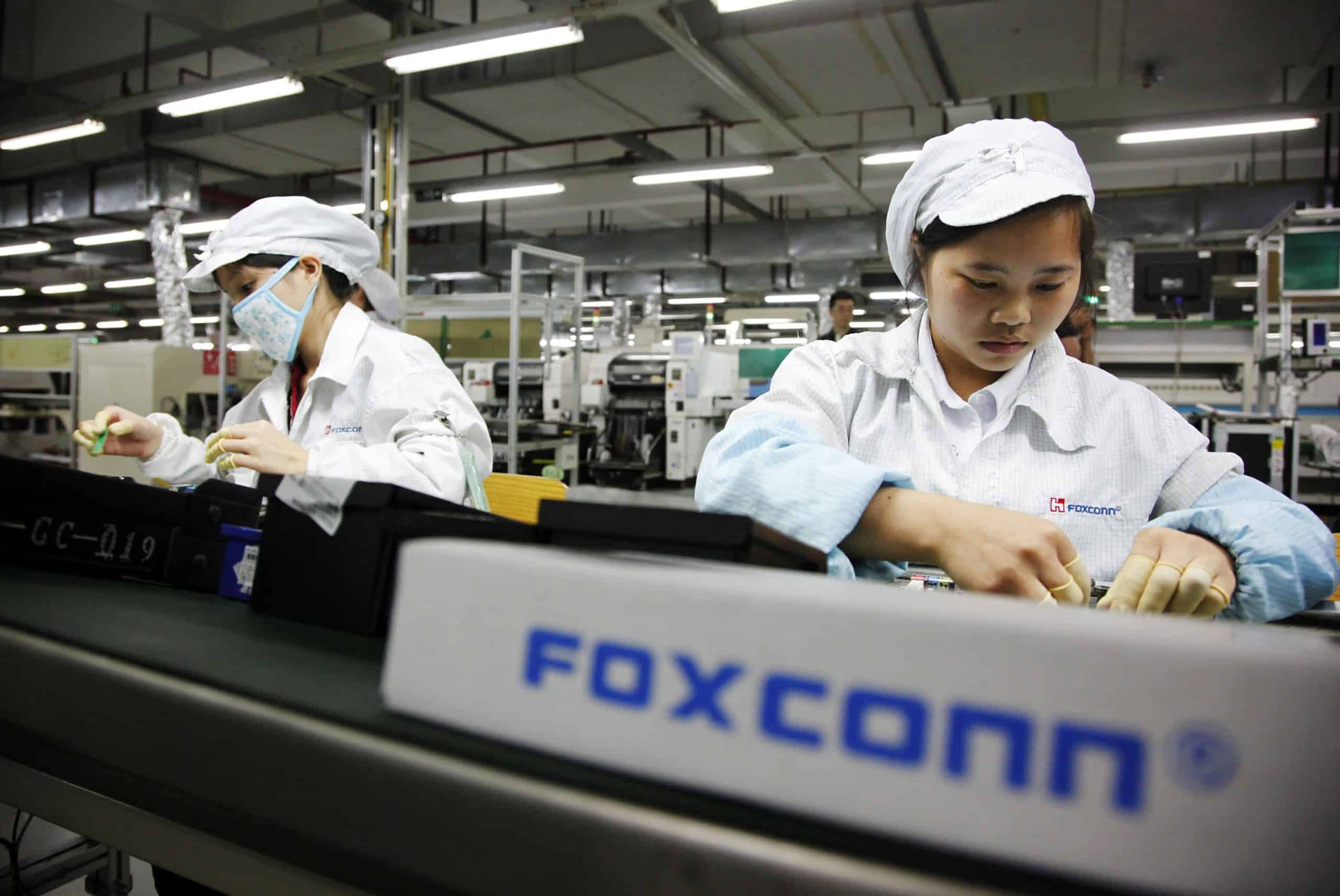 Workers assembling products at a Foxconn factory.