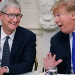 Tim Cook and Donald Trump sharing a conversation.