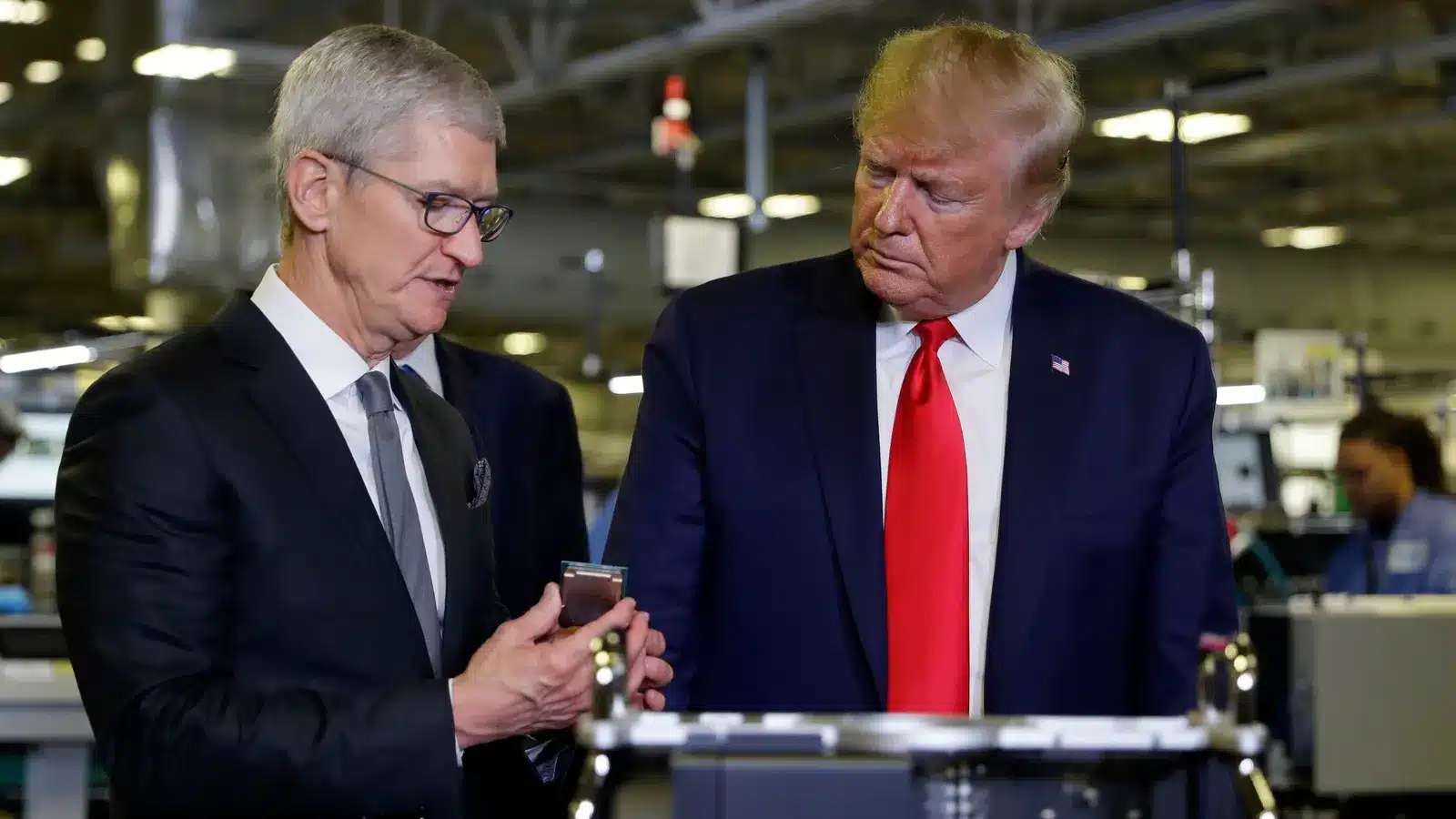 Tim Cook and Donald Trump at a factory.