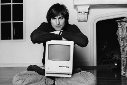 Steve Jobs with the original Macintosh computer.