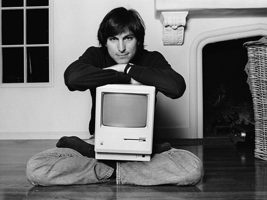 Steve Jobs with the original Macintosh computer.