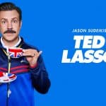 Jason Sudeikis as Ted Lasso holding a teacup.