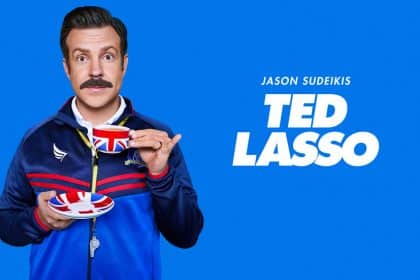 Jason Sudeikis as Ted Lasso holding a teacup.