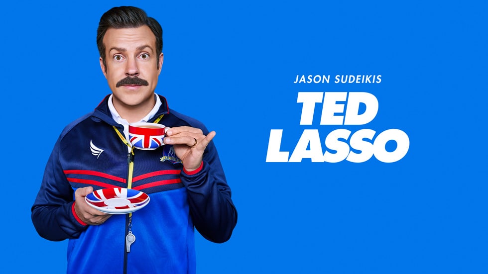 Jason Sudeikis as Ted Lasso holding a teacup.