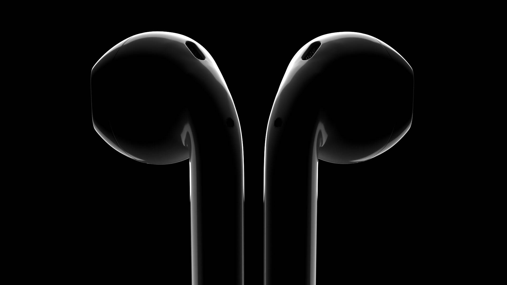 Close-up of black AirPods on a dark background.