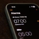 iPhone alarm screen showing set wake-up times.