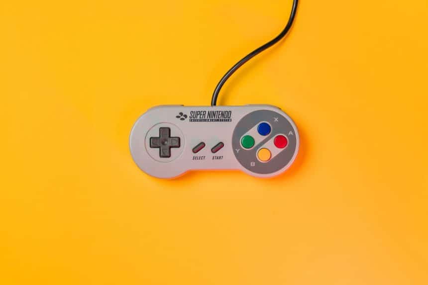 Super Nintendo controller on a bright yellow background.