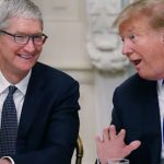 Tim Cook and Donald Trump in a discussion during a public meeting.