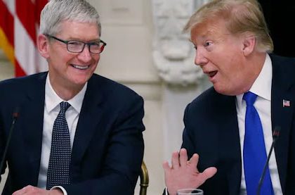 Tim Cook and Donald Trump in a discussion during a public meeting.