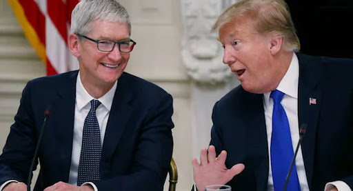 Tim Cook and Donald Trump in a discussion during a public meeting.