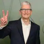 Apple CEO Tim Cook making a peace sign gesture.