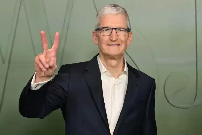 Apple CEO Tim Cook making a peace sign gesture.