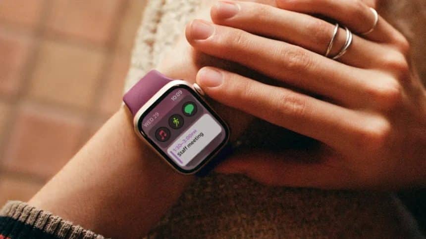 A person wearing an Apple Watch with a purple band.