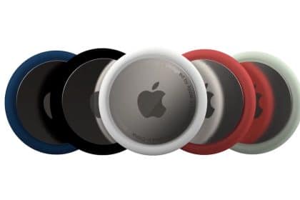 A set of Apple AirTags in various colours, including black, white, red, and green.