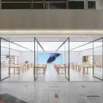 Apple Store inside Northbrook Court mall with glass walls and wooden tables.