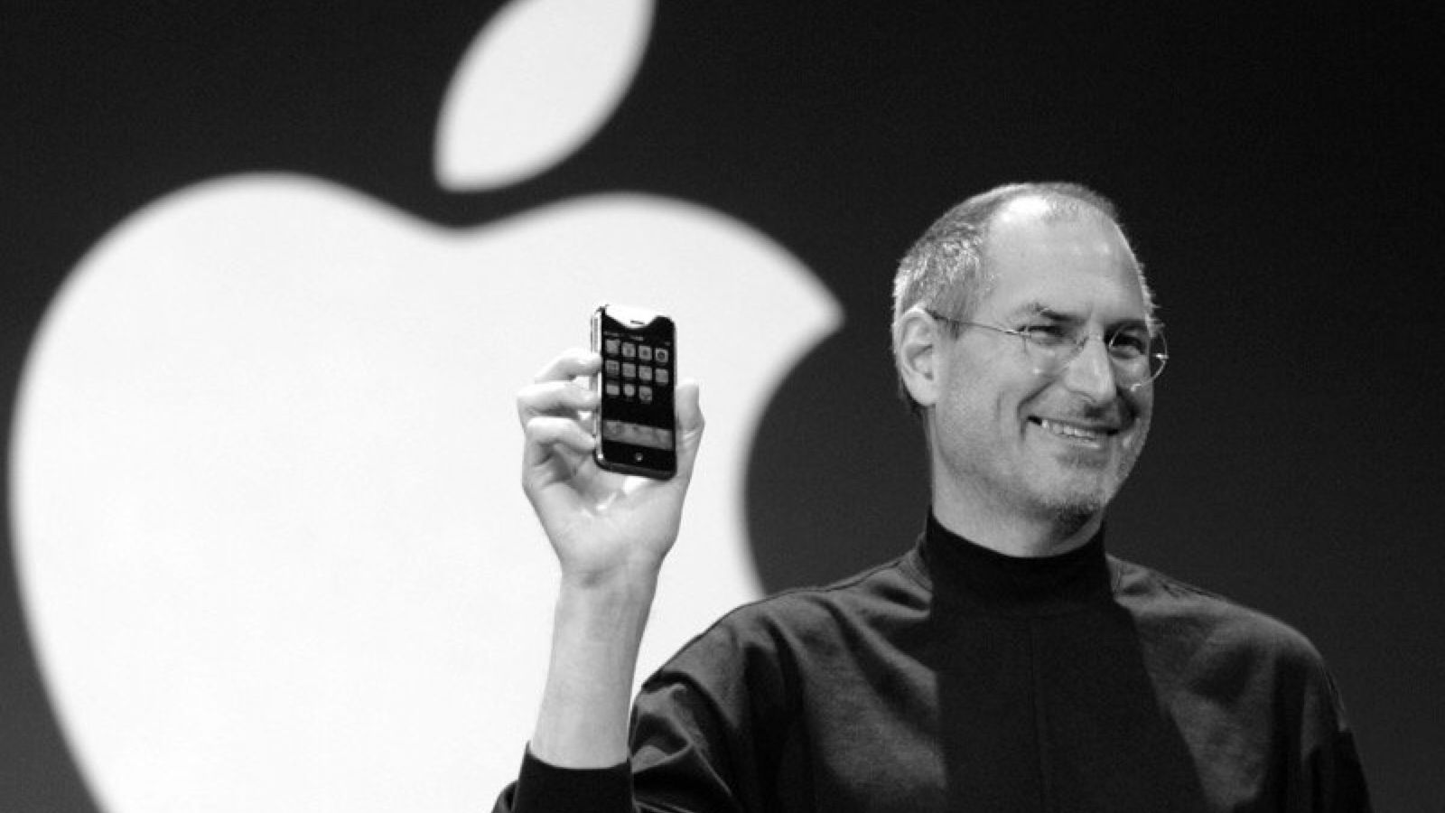 Steve Jobs holding the first iPhone during its 2007 launch event.