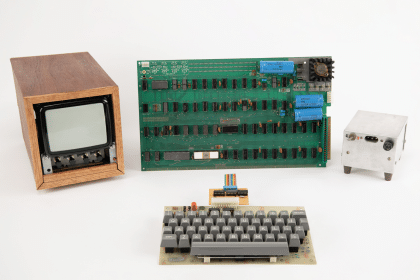 Apple-1 computer with original keyboard, monitor, power supply, and circuit board.