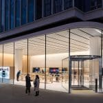 Apple Store in Hongdae, South Korea, with a modern glass facade and interior displays.