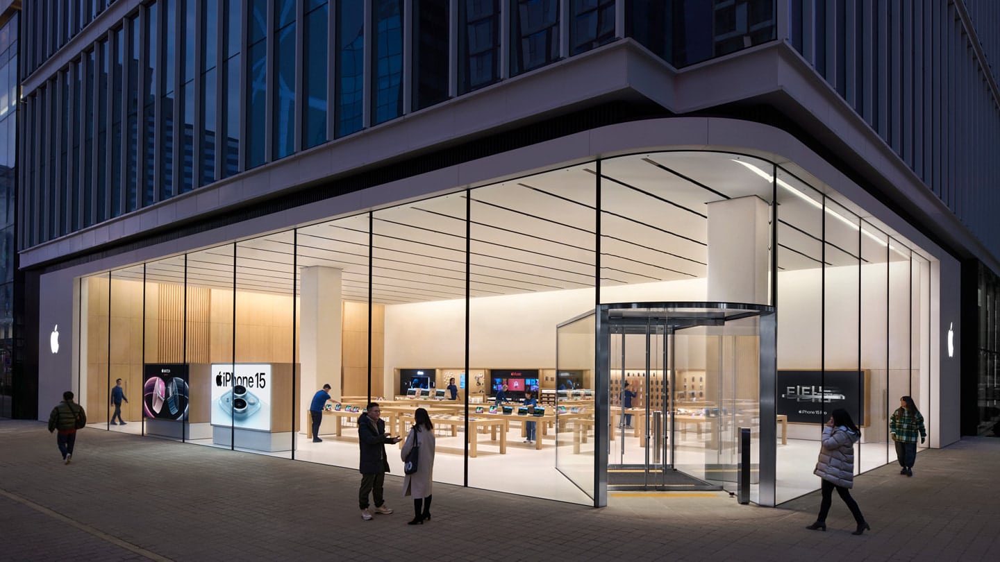 Apple Store in Hongdae, South Korea, with a modern glass facade and interior displays.