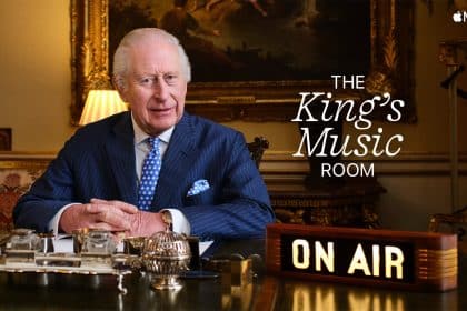 King Charles III hosting The King's Music Room on Apple Music 1, with an "On Air" sign in front of him.